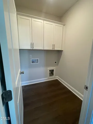 a view of storage and utility room with wooden floor