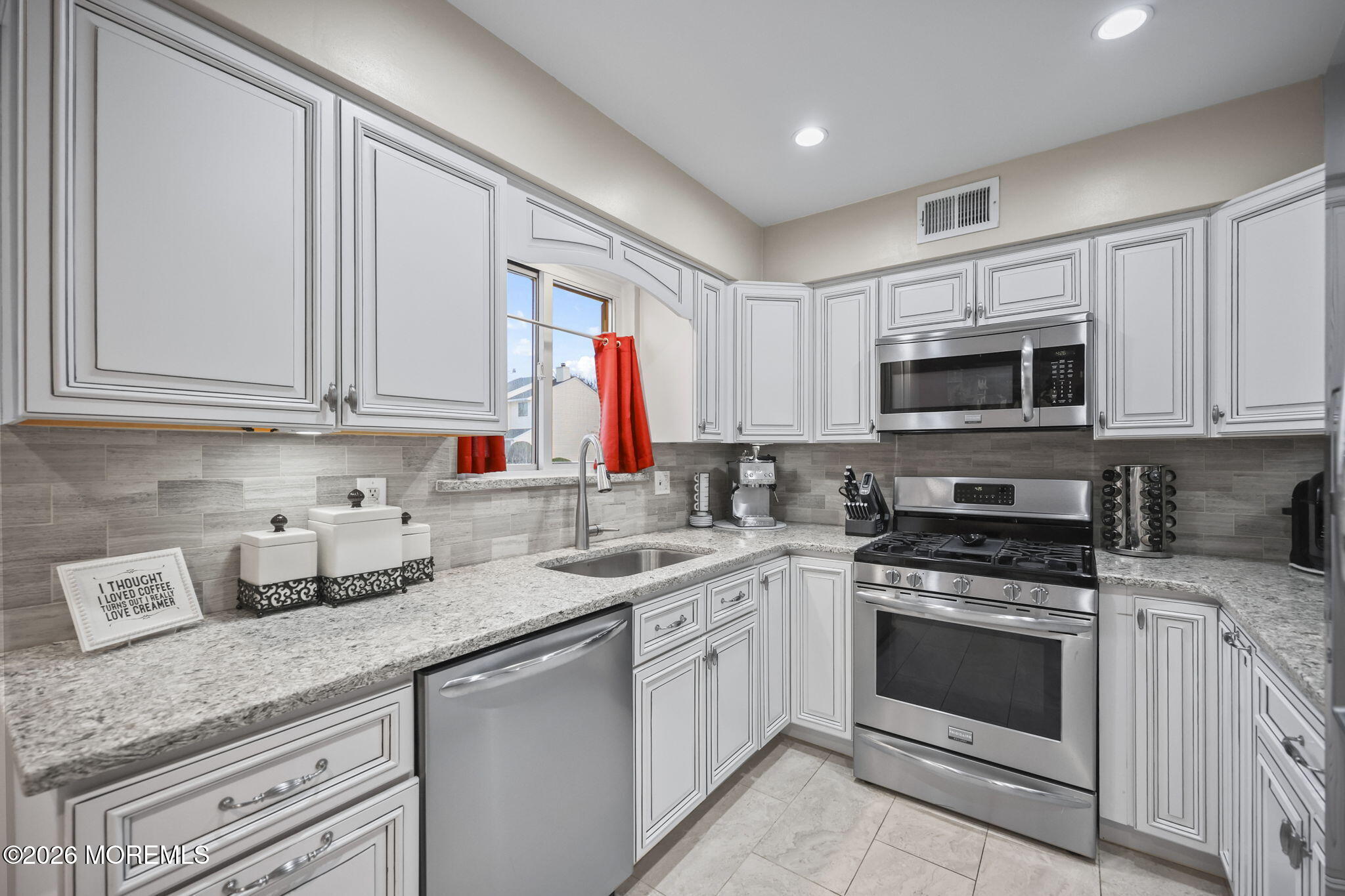 316 Middlewood Road Middletown, NJ 07748 - Photo 14 of 33 a kitchen with granite countertop a sink stove and microwave