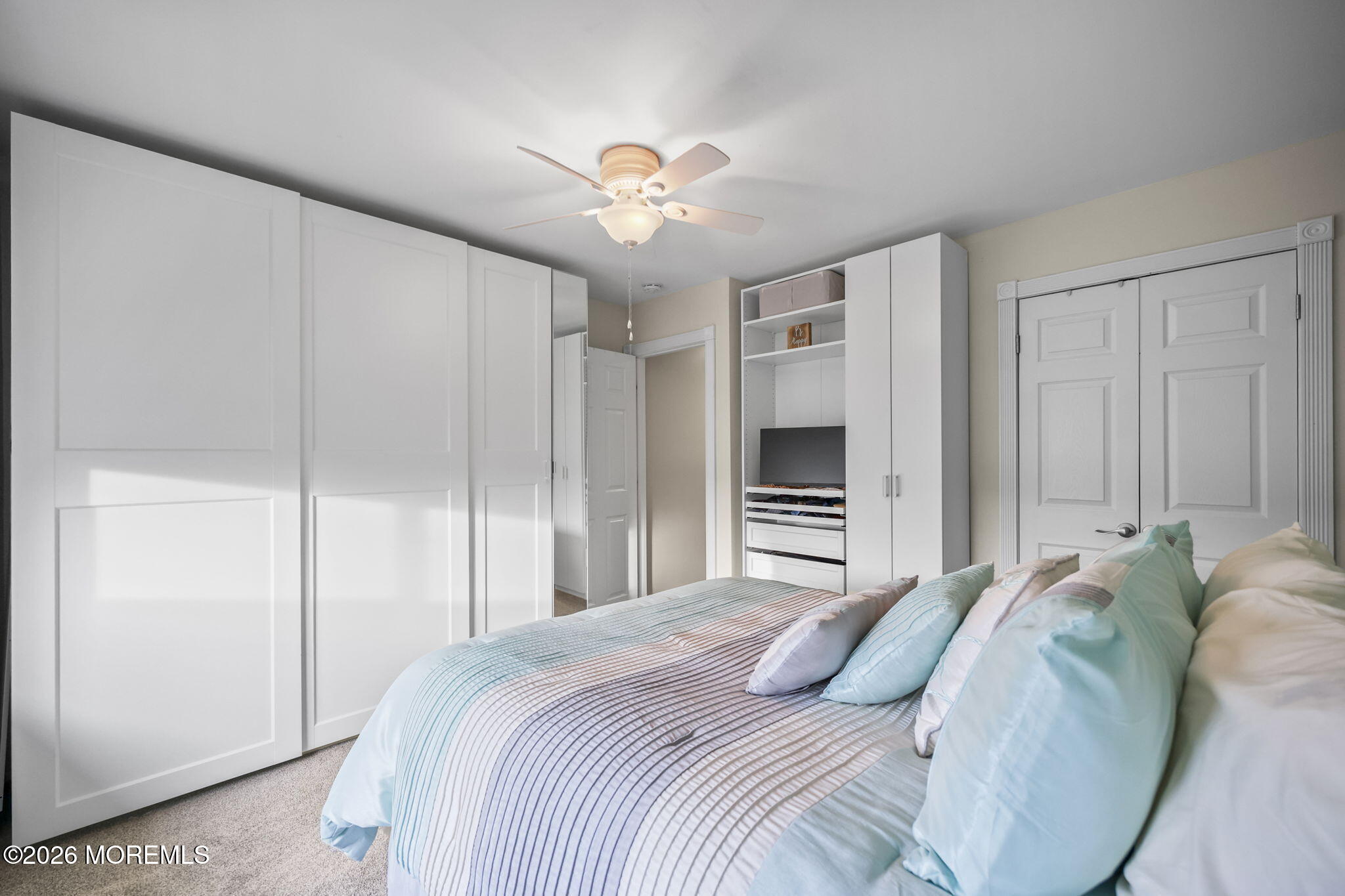 316 Middlewood Road Middletown, NJ 07748 - Photo 22 of 33 a bedroom with a bed and a chandelier