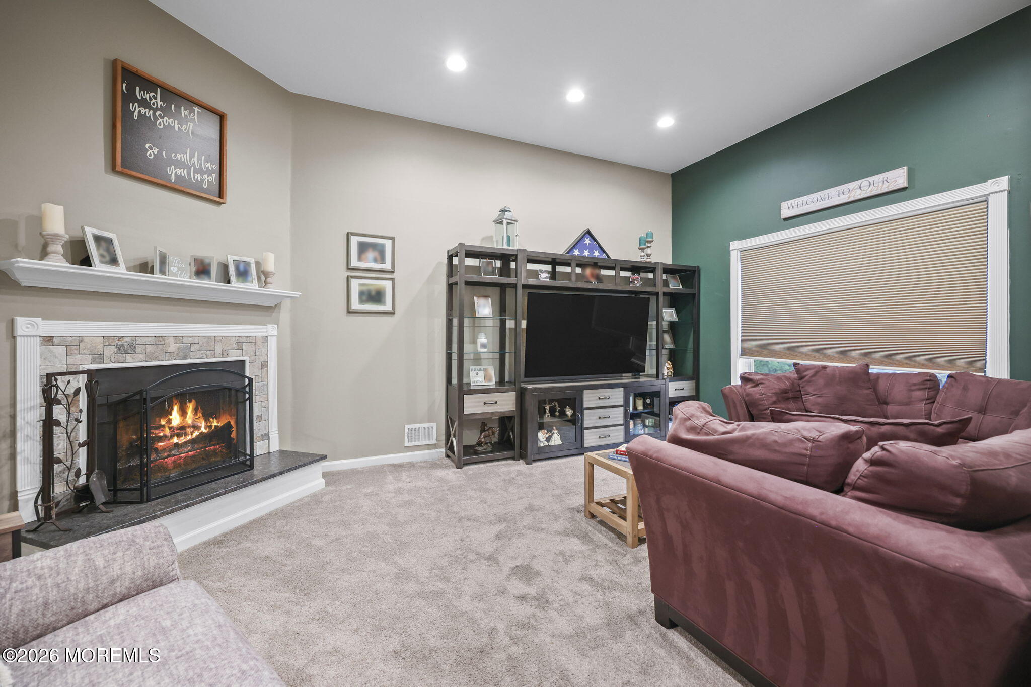 316 Middlewood Road Middletown, NJ 07748 - Photo 4 of 33 a living room with furniture a flat screen tv and a fireplace