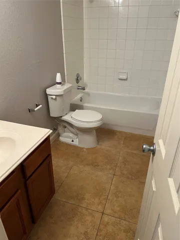 a bathroom with a toilet a sink and bathtub