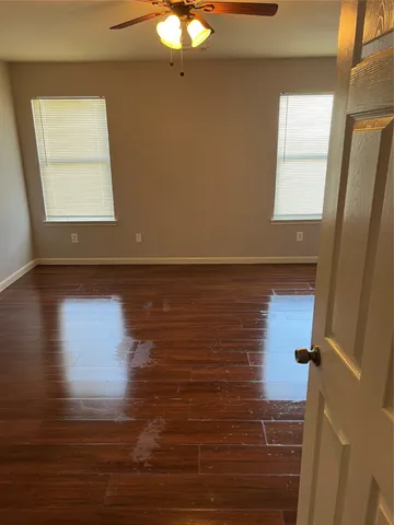 a view of room with window and wooden floor