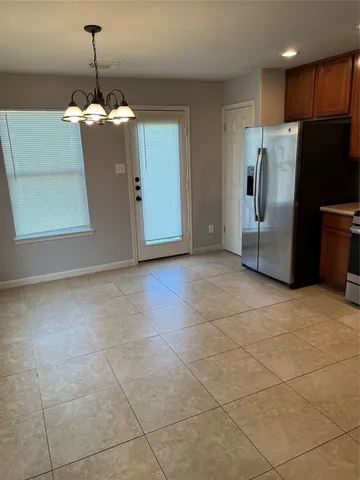 a kitchen with granite countertop a refrigerator and a stove