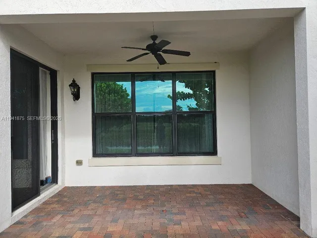 a view of entryway with window and ceiling fan
