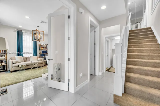 a view of a livingroom with furniture and stairs