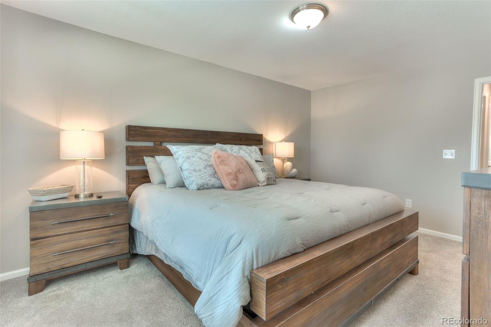 3550 Fennel Street Castle Rock, CO 80109 - Photo 14 of 37 a bedroom with a bed and lamp