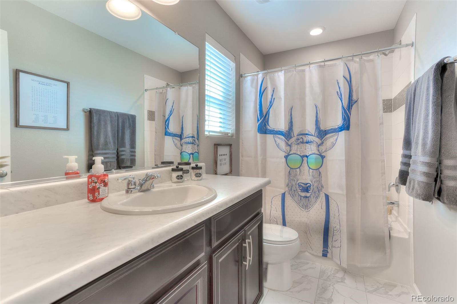 3550 Fennel Street Castle Rock, CO 80109 - Photo 24 of 37 a bathroom with a double vanity sink toilet and shower