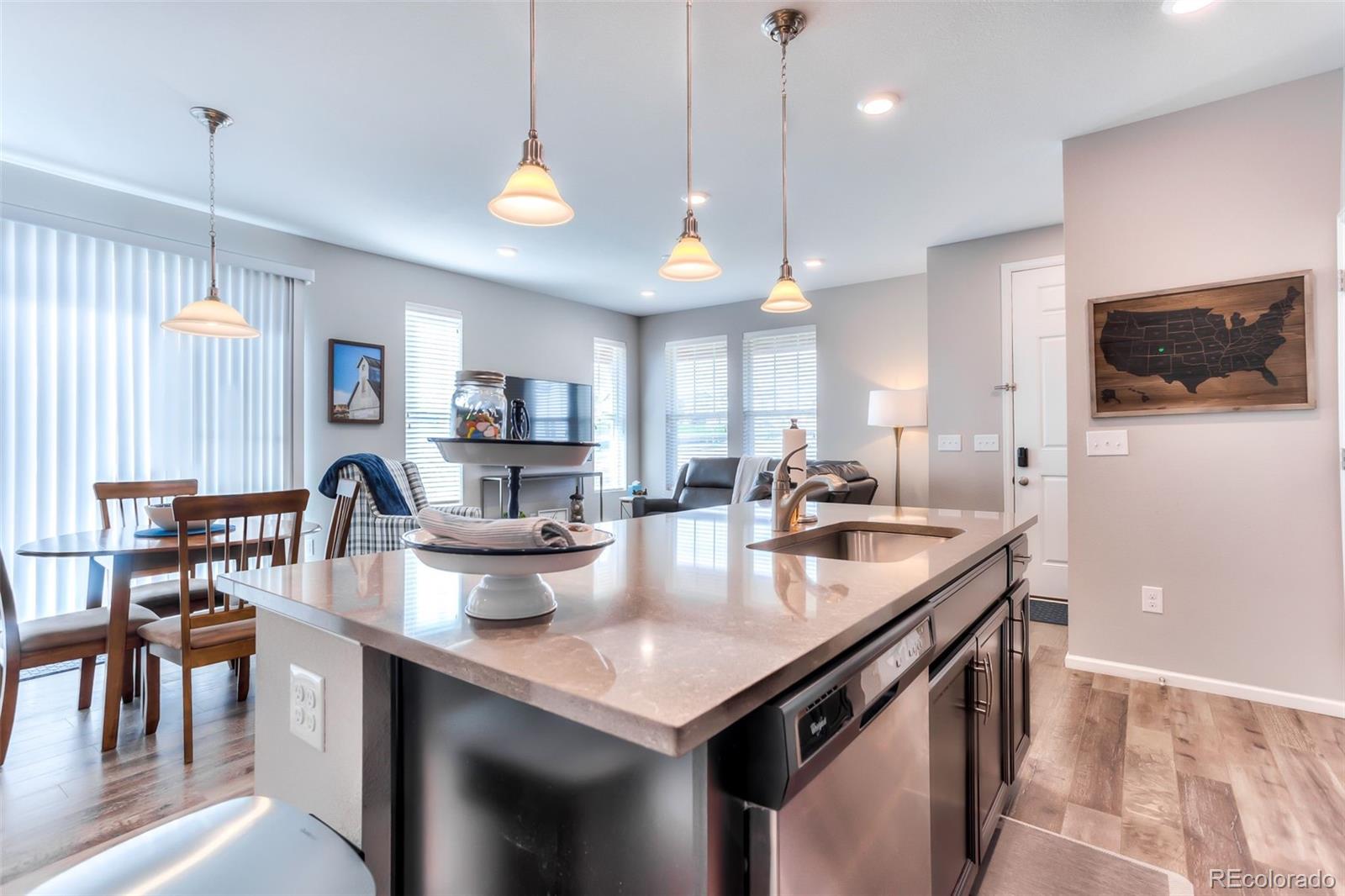 3550 Fennel Street Castle Rock, CO 80109 - Photo 4 of 37 a kitchen with sink stove and a refrigerator with wooden floor