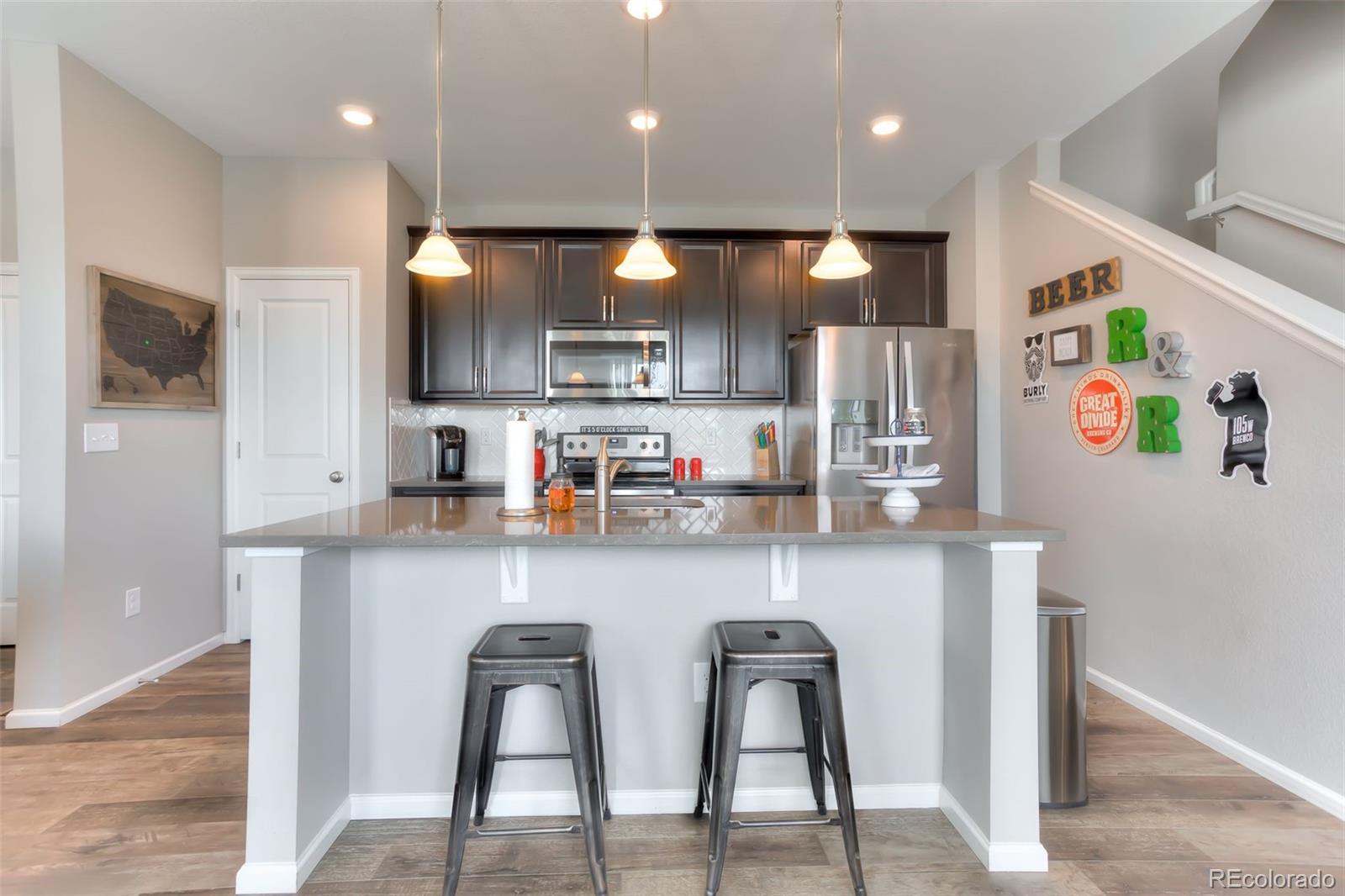3550 Fennel Street Castle Rock, CO 80109 - Photo 5 of 37 a kitchen with stainless steel appliances a sink and cabinets