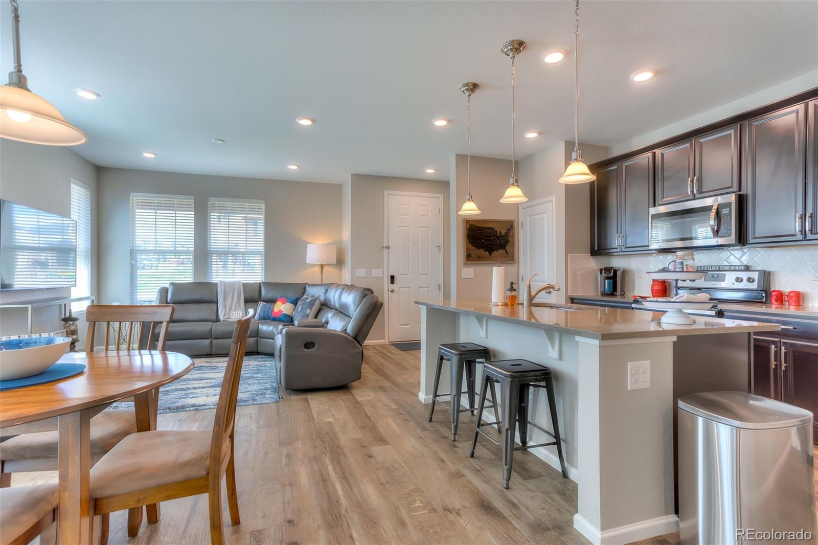 3550 Fennel Street Castle Rock, CO 80109 - Photo 8 of 37 a living room with stainless steel appliances kitchen island granite countertop furniture and a wooden cabinets