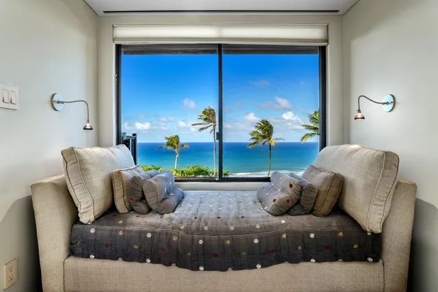 a bedroom with furniture and a potted plant