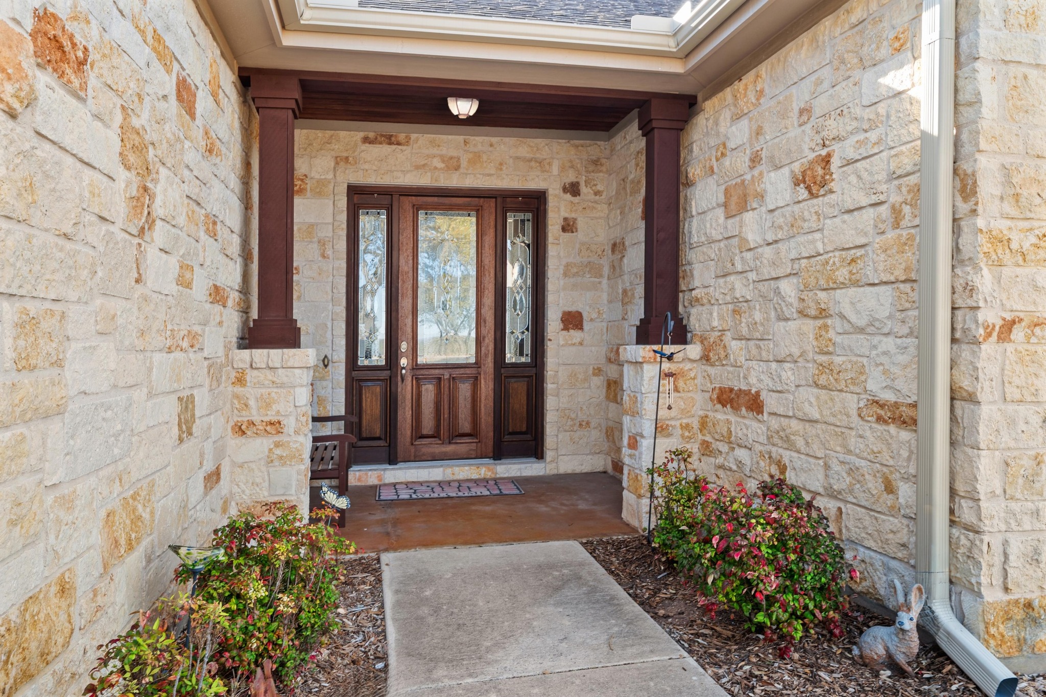 28701 Valley Road Marble Falls, TX 78654 - Photo 7 of 35 a front view of a house with a garden