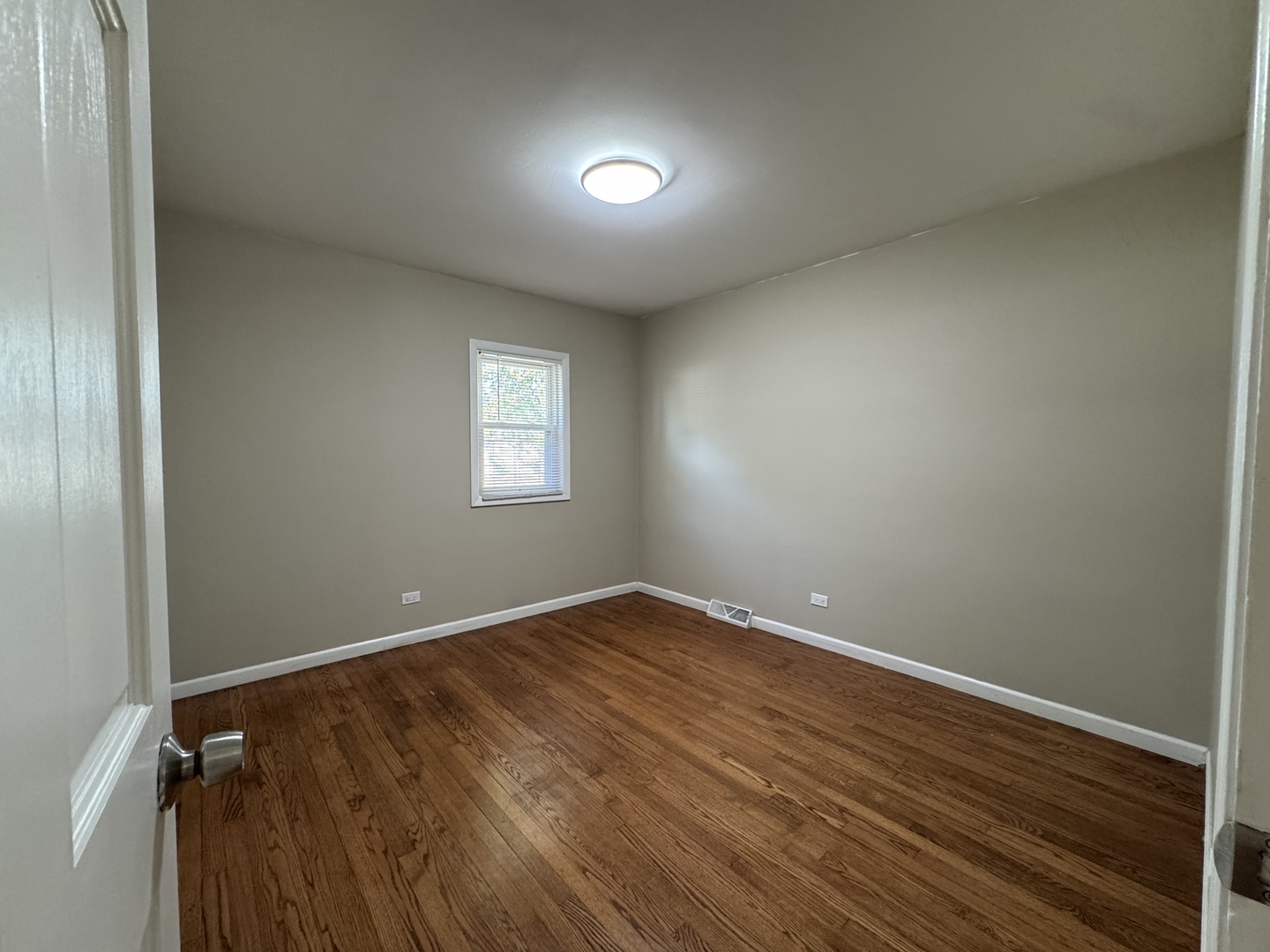 7838 West 73rd Place Bridgeview, IL 60455 - Photo 13 of 22 an empty room with wooden floor and windows