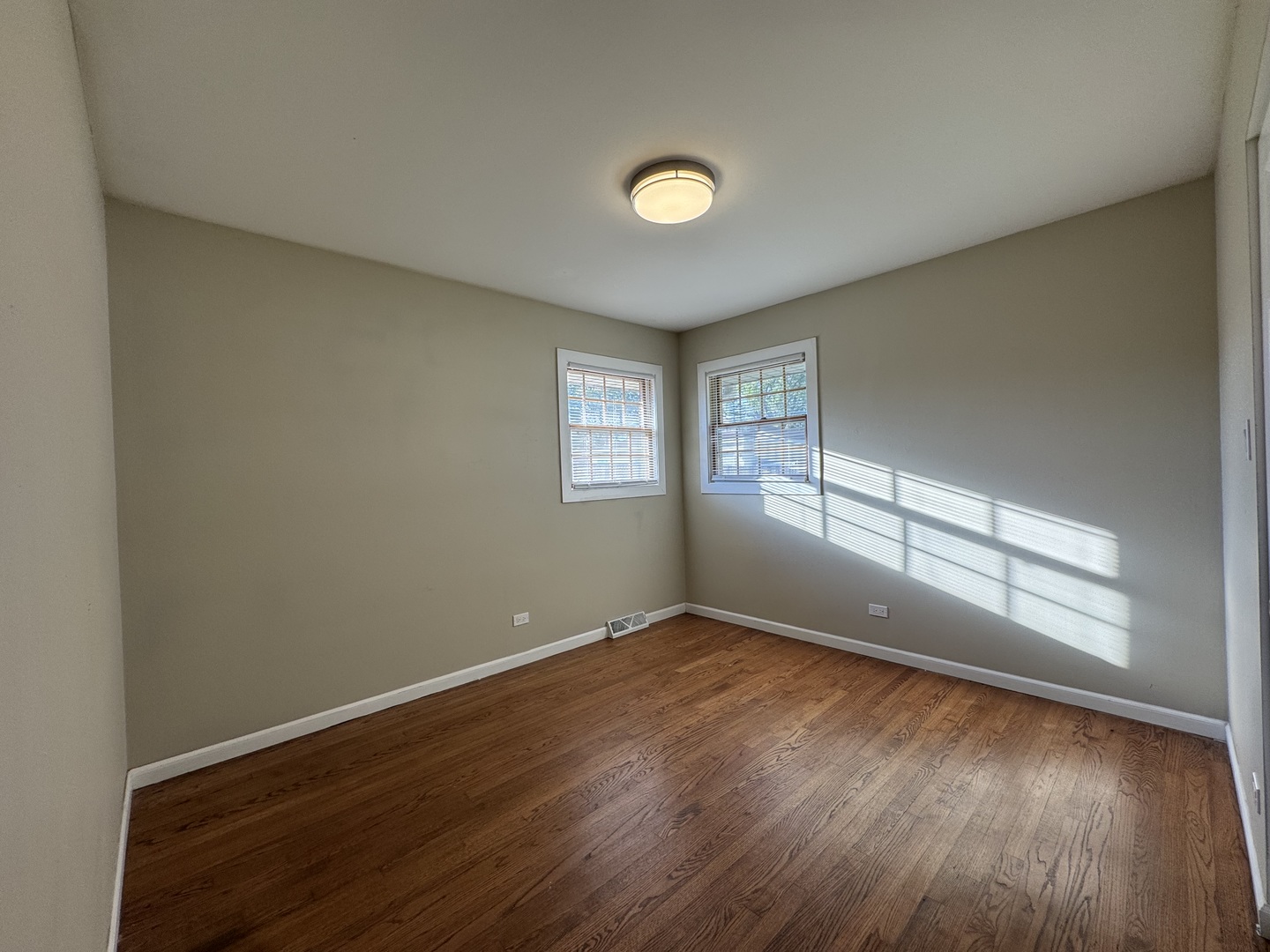 7838 West 73rd Place Bridgeview, IL 60455 - Photo 15 of 22 an empty room with wooden floor and windows
