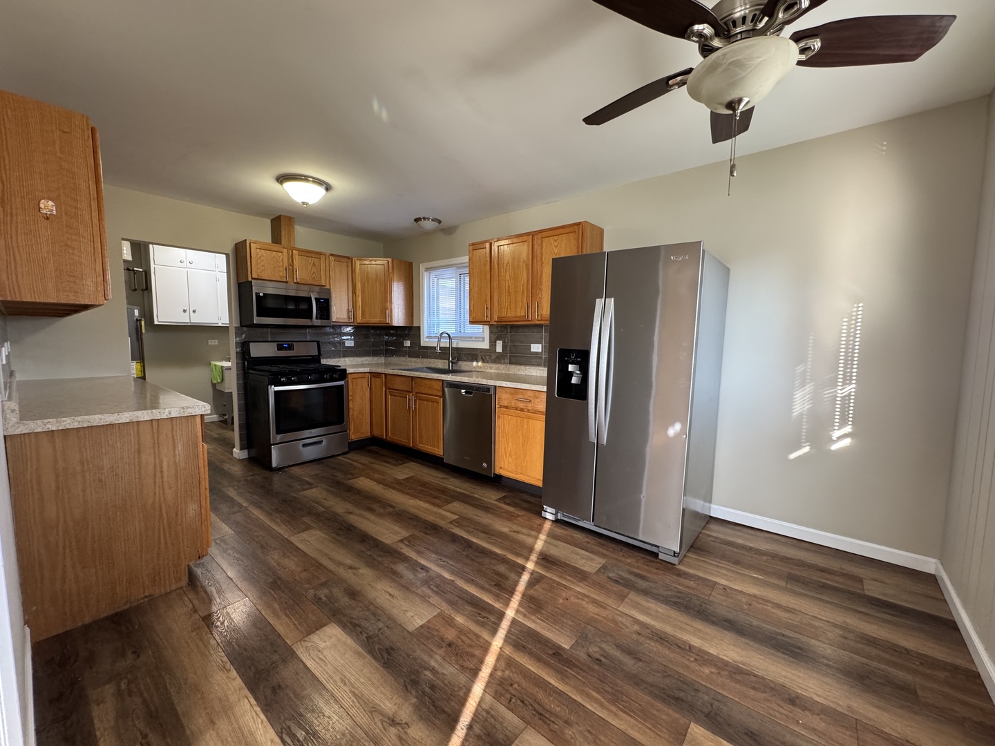 7838 West 73rd Place Bridgeview, IL 60455 - Photo 3 of 22 a kitchen with stainless steel appliances a stove a refrigerator and a refrigerator