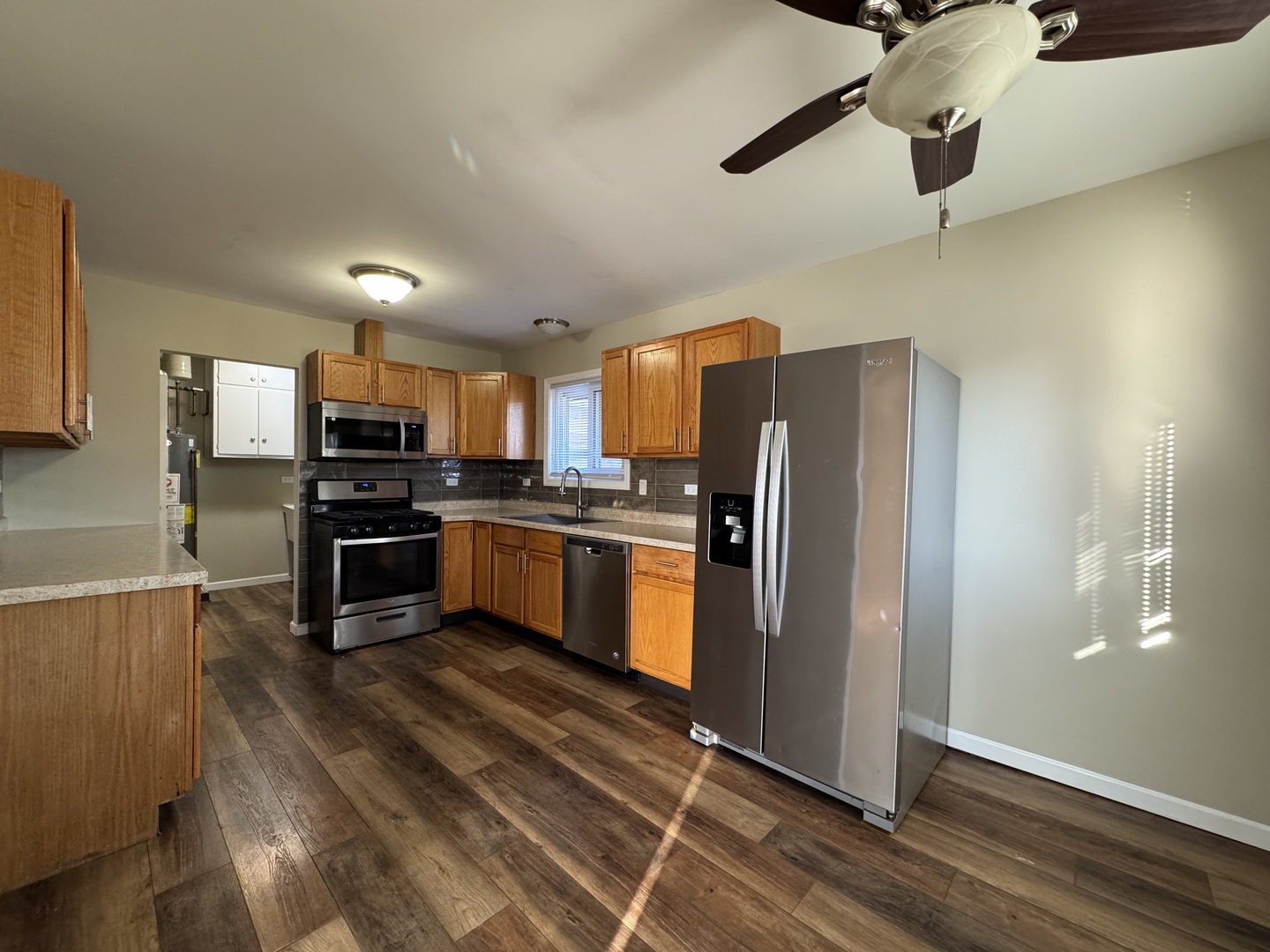 7838 West 73rd Place Bridgeview, IL 60455 - Photo 4 of 22 a kitchen with stainless steel appliances a refrigerator and a stove top oven