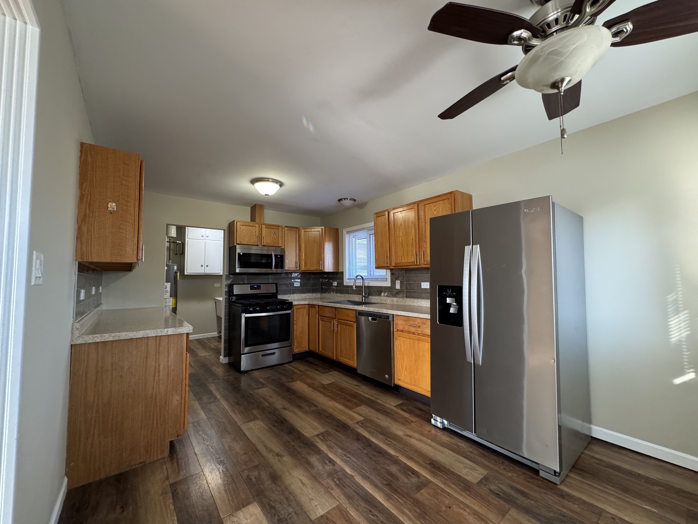 7838 West 73rd Place Bridgeview, IL 60455 - Photo 5 of 22 a kitchen with stainless steel appliances granite countertop a refrigerator and a stove