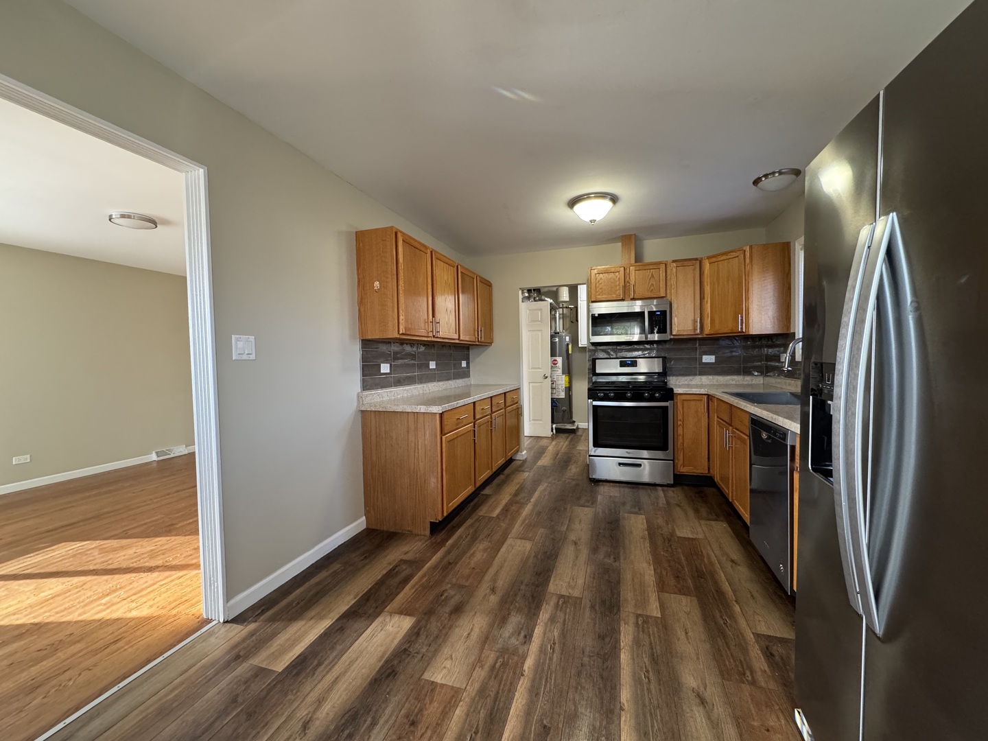 7838 West 73rd Place Bridgeview, IL 60455 - Photo 6 of 22 a kitchen with stainless steel appliances a stove a sink a microwave a refrigerator and cabinets