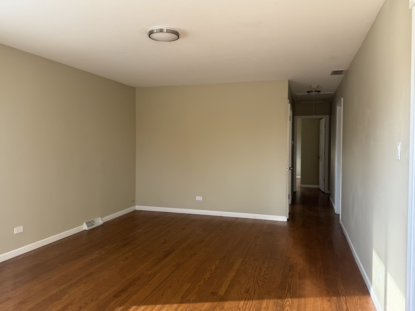 7838 West 73rd Place Bridgeview, IL 60455 - Photo 9 of 22 a view of an empty room with wooden floor and a window