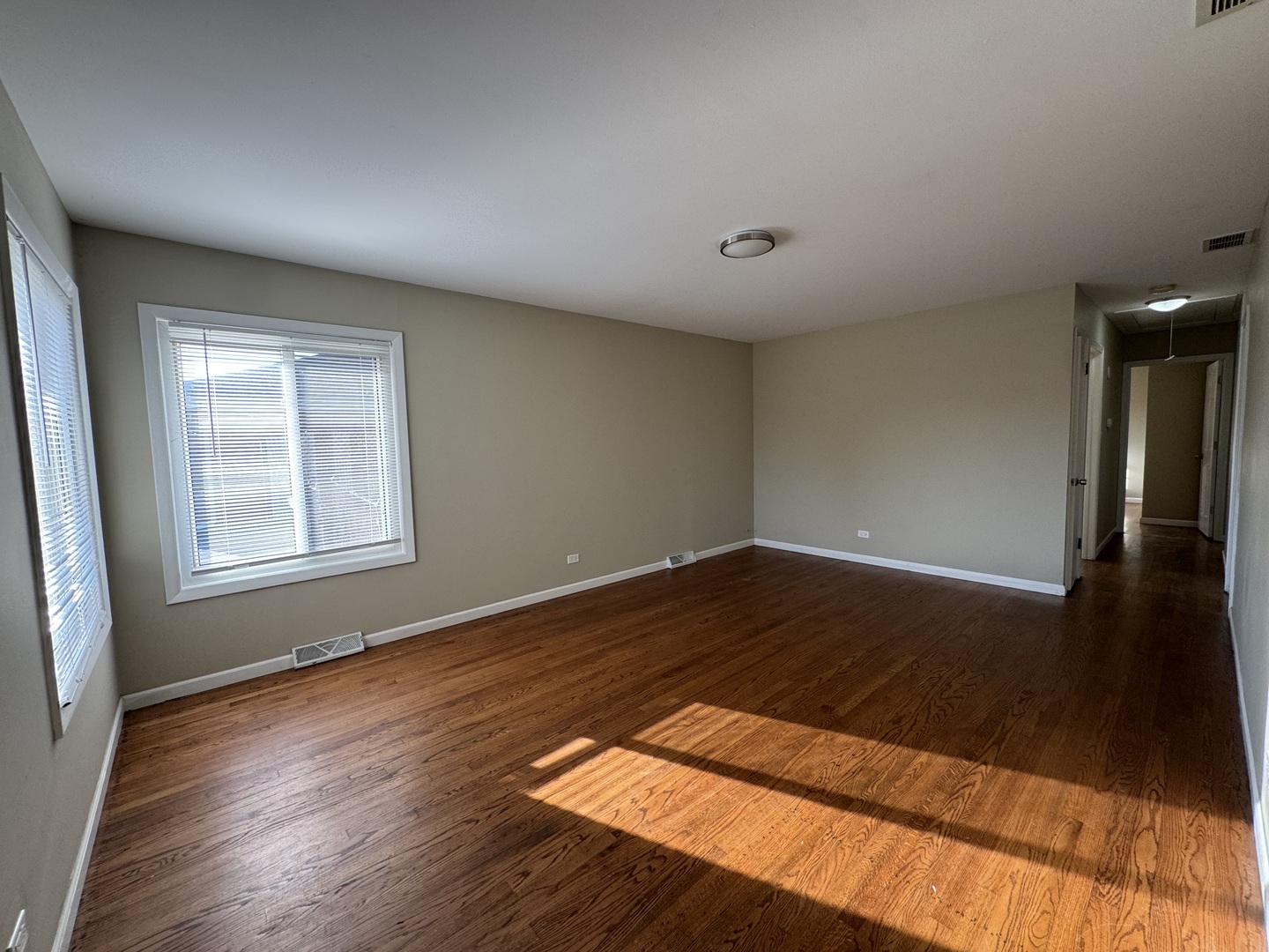7838 West 73rd Place Bridgeview, IL 60455 - Photo 10 of 22 a view of wooden floor and windows in a room