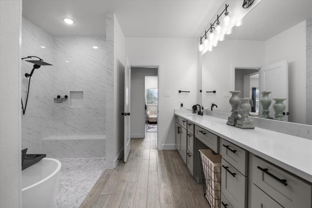 1039 Monaco Court Springtown, TX 76082 - Photo 14 of 33 Primary bathroom featuring a large vanity with a walk-in shower with a built-in bench