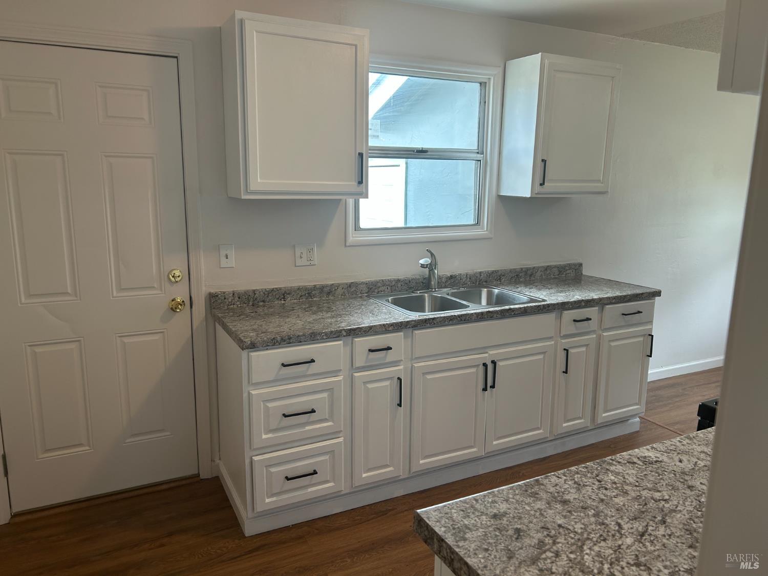 243 Sage Street Vallejo, CA 94589 - Photo 2 of 9 a kitchen with a sink cabinets and wooden floor