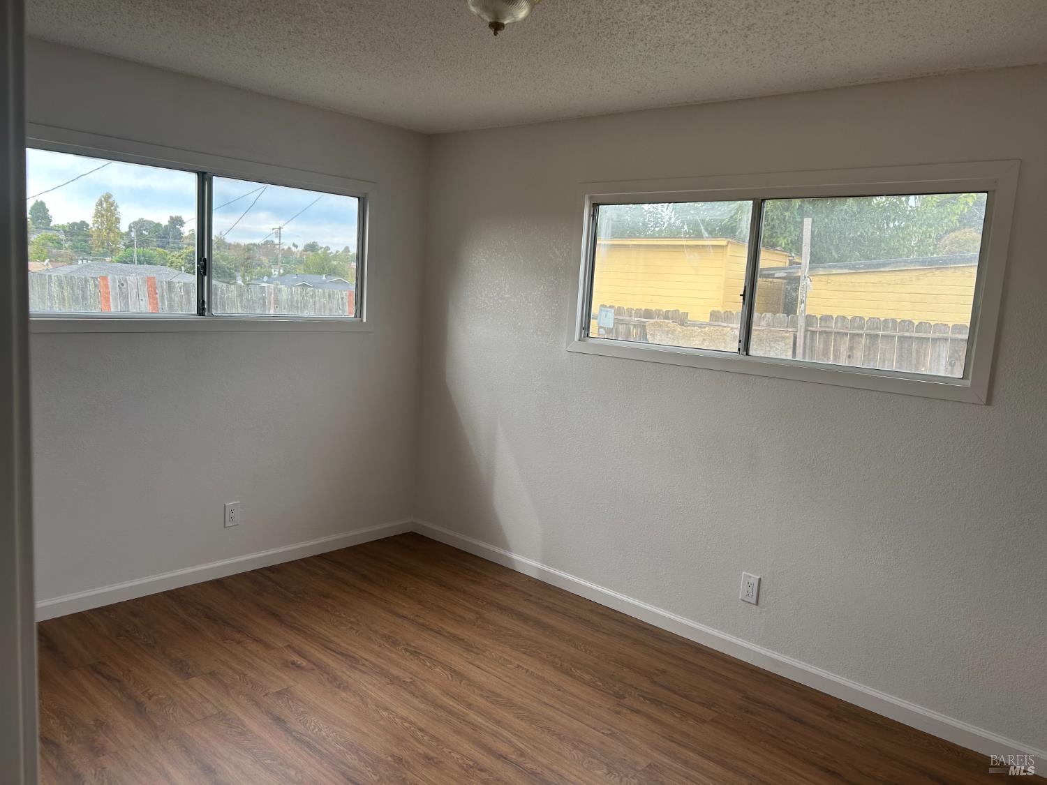 243 Sage Street Vallejo, CA 94589 - Photo 7 of 9 a view of an empty room with wooden floor and a window
