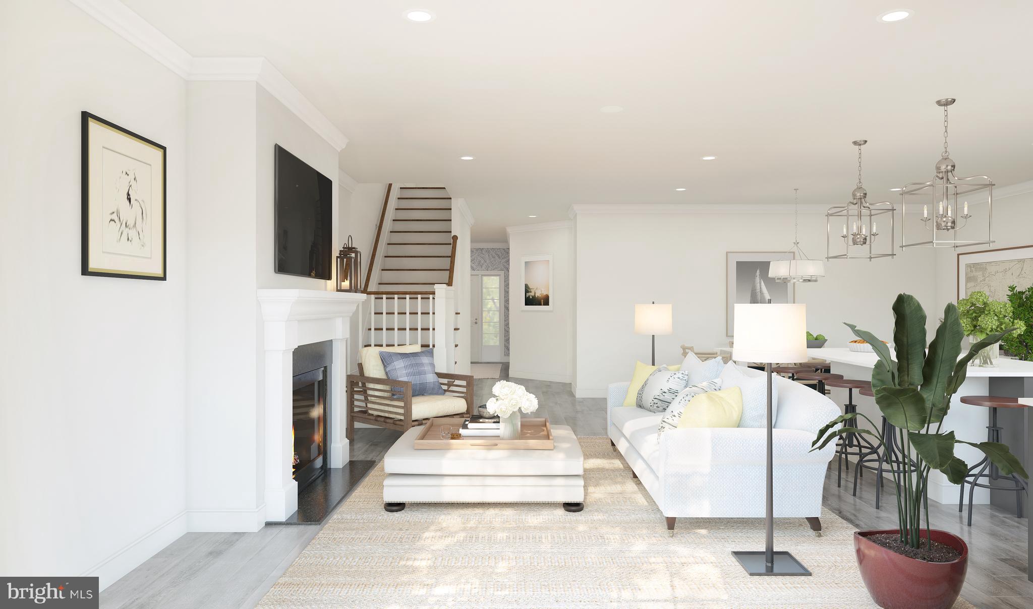 1005 Justin Drive, Unit 1002 West Windsor, NJ 08550 - Photo 5 of 14 a living room with furniture a fireplace and a potted plant