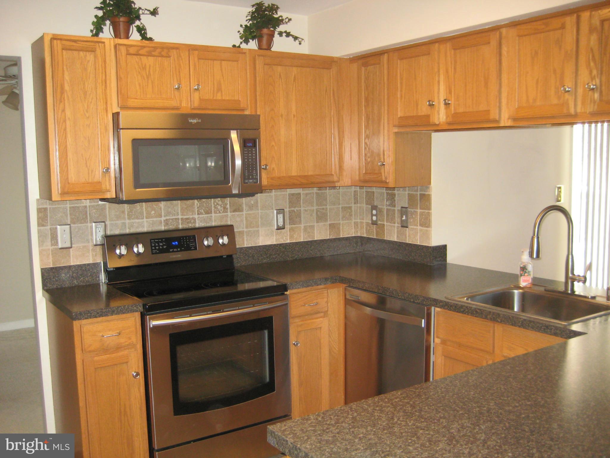 7304 Gunpowder Road Baltimore, MD 21220 - Photo 1 of 30 a kitchen with a stove and a sink
