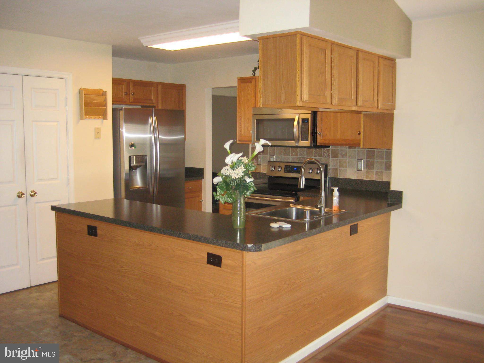 7304 Gunpowder Road Baltimore, MD 21220 - Photo 15 of 30 a kitchen with stainless steel appliances granite countertop a refrigerator a stove and a sink