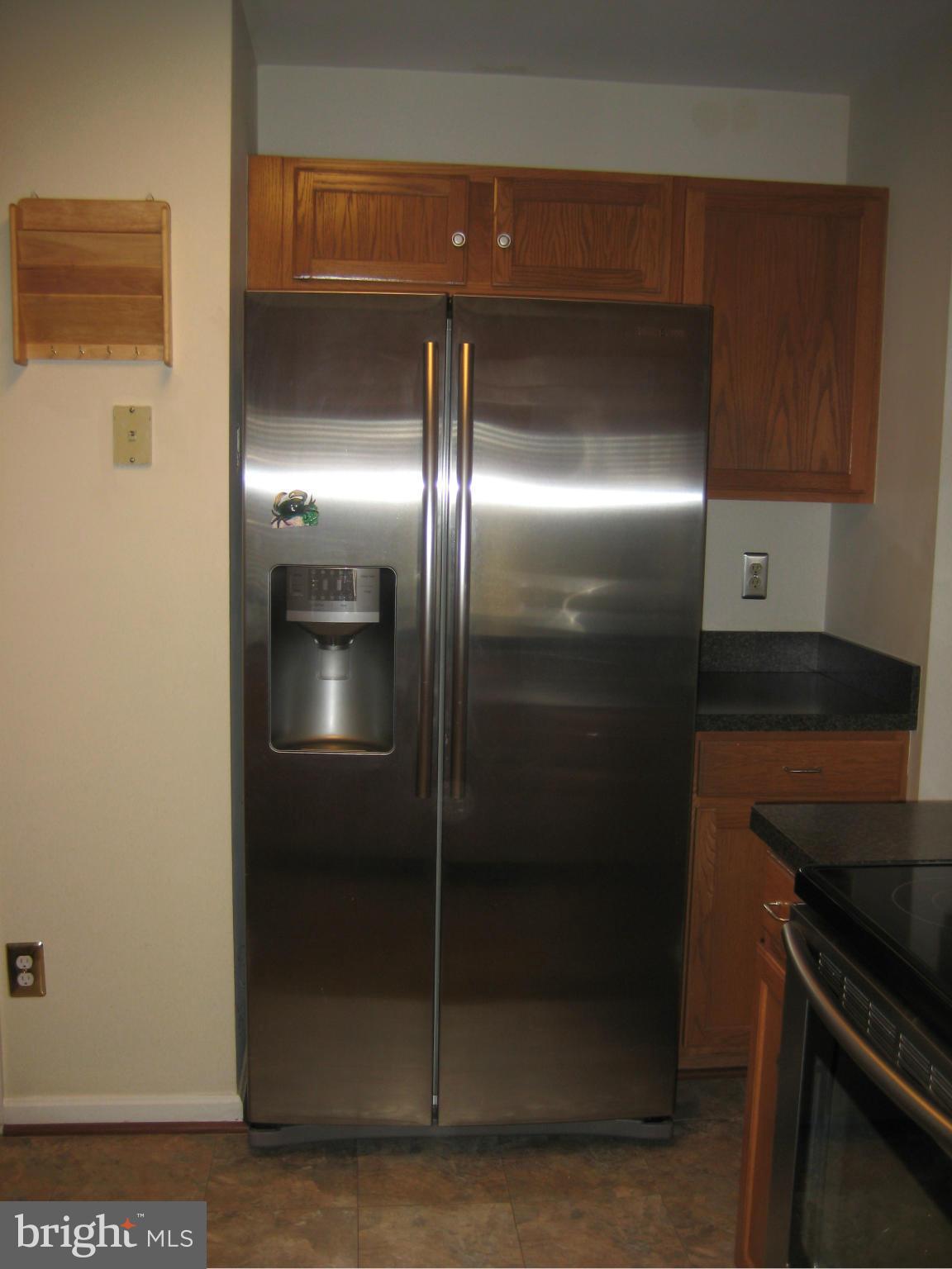 7304 Gunpowder Road Baltimore, MD 21220 - Photo 16 of 30 a metallic refrigerator freezer sitting in a kitchen