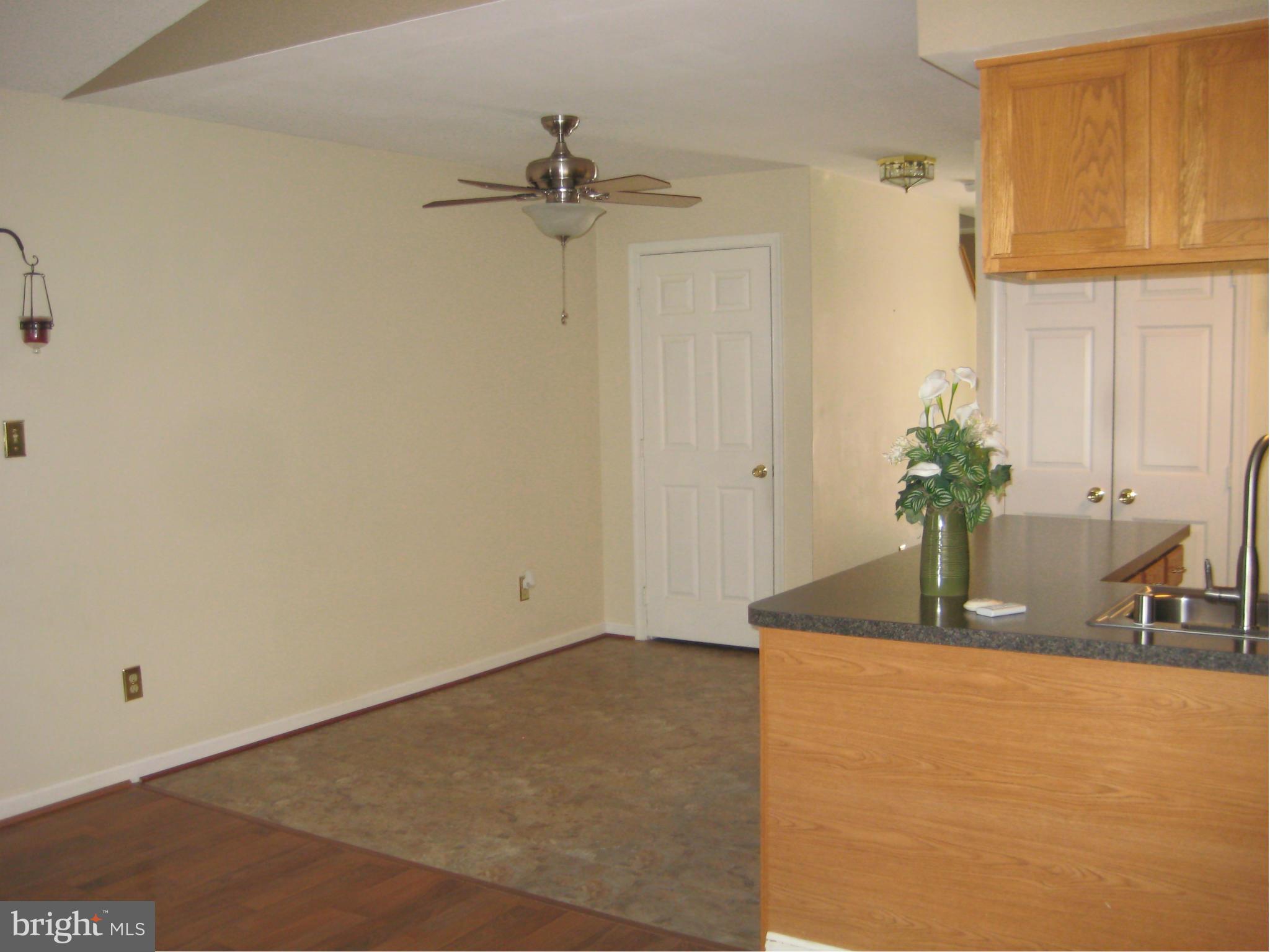 7304 Gunpowder Road Baltimore, MD 21220 - Photo 19 of 30 a room with a chandelier fan and wooden floor