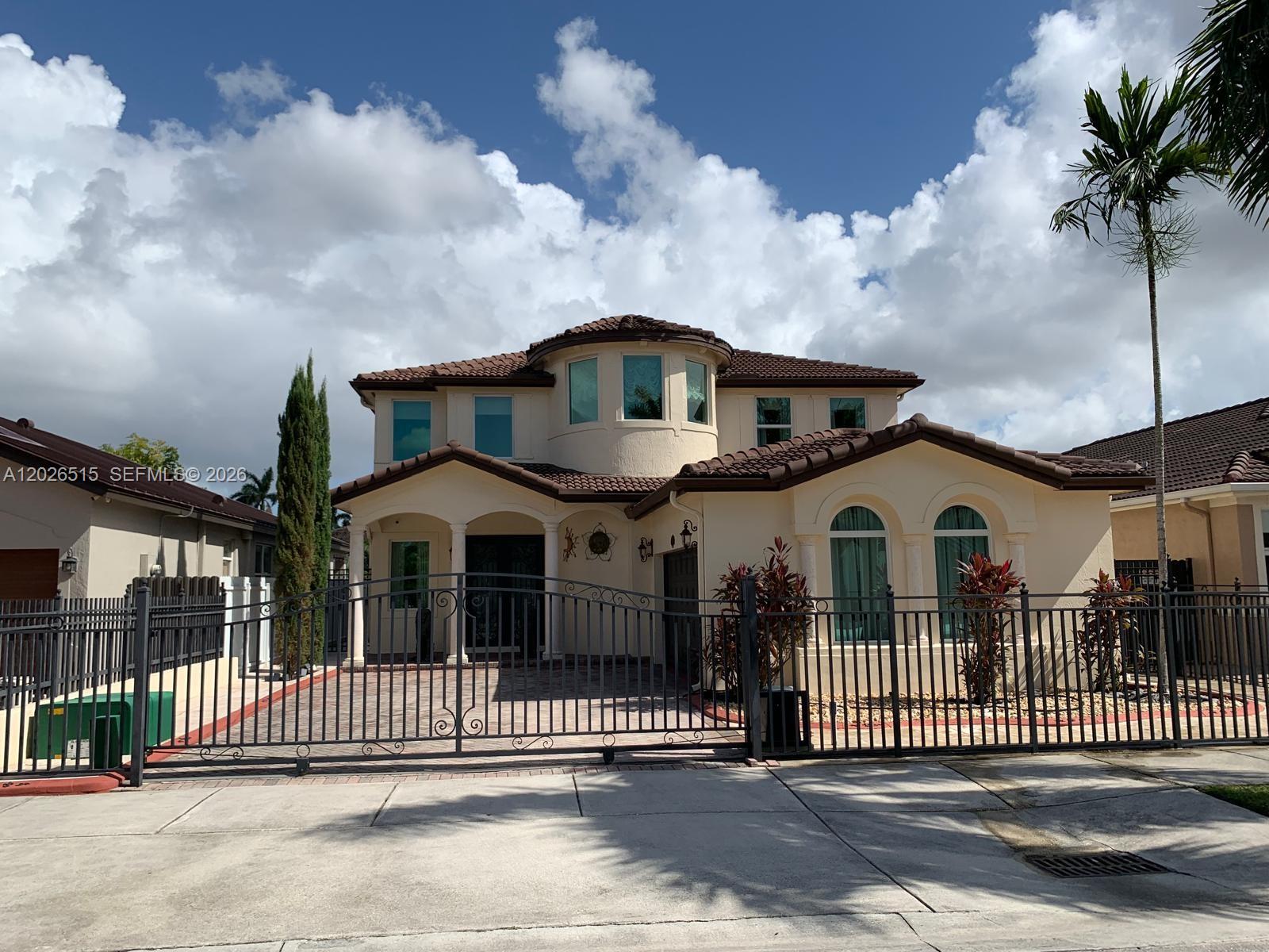 1065 Southwest 150th Place Miami, FL 33194 - Photo 2 of 14 a front view of a house with a yard