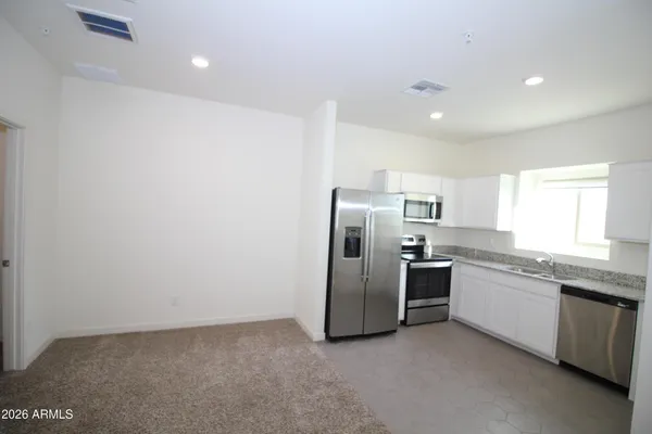 a kitchen with stainless steel appliances a refrigerator and a sink