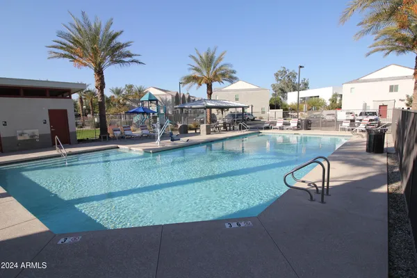 a view of a swimming pool with outdoor seating