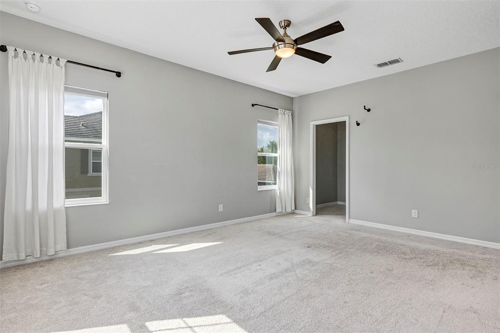 7644 Ripplepointe Way Windermere, FL 34786 - Photo 22 of 52 a view of a livingroom with a ceiling fan and window