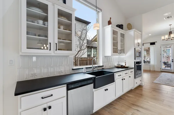 a kitchen with stainless steel appliances a stove microwave and sink