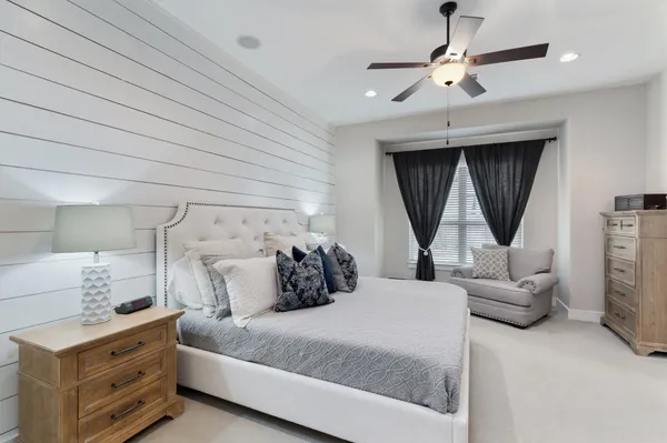 a spacious bedroom with a bed and a television