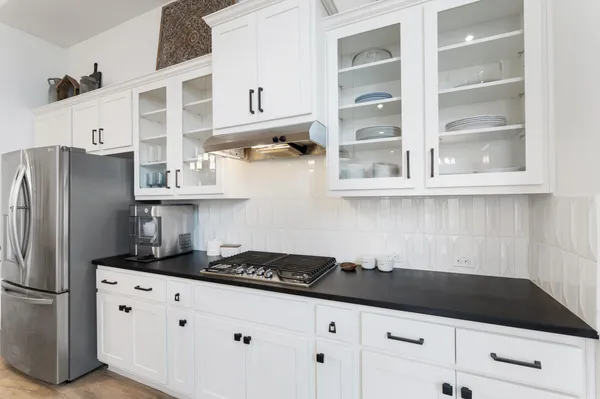 a kitchen with granite countertop a cabinets and refrigerator