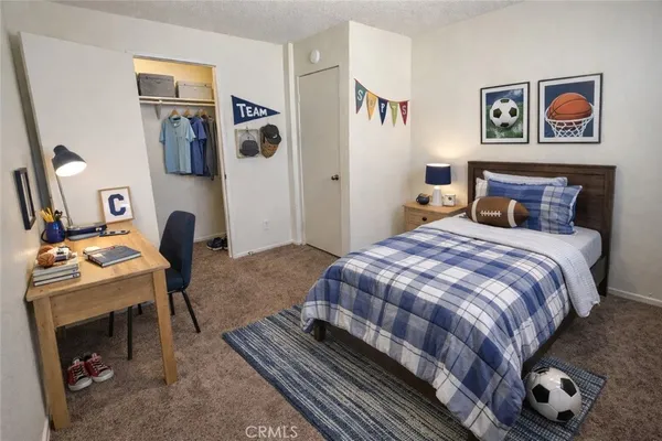 a bedroom with a bed and dresser