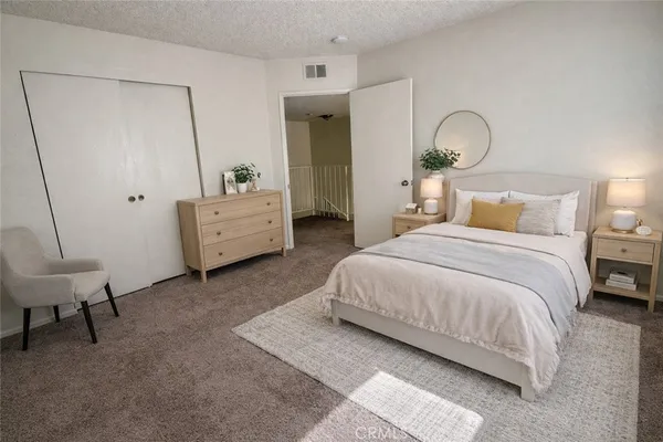 a bedroom with a bed and a dresser