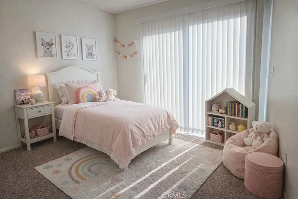a bedroom with a bed and a couch