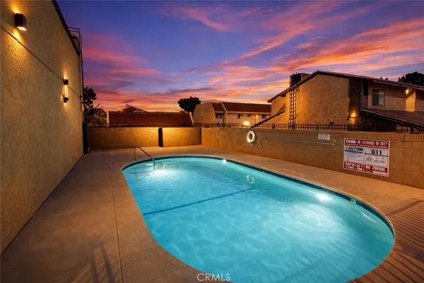 a view of a swimming pool with a yard