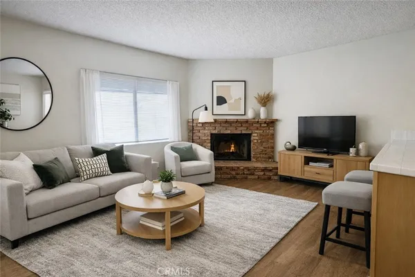 a living room with furniture a rug and a fireplace