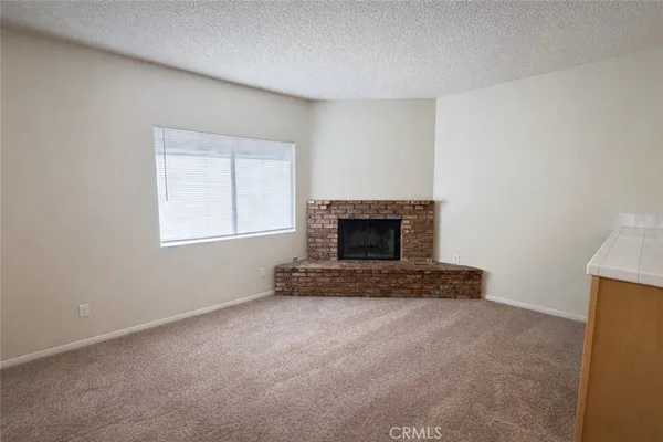 a view of empty room with a fireplace