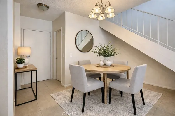 a dining room with furniture and a mirror