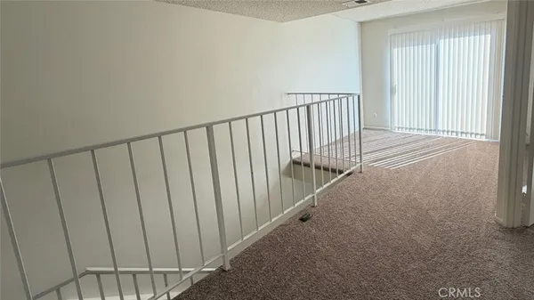 a view of staircase with rug floor