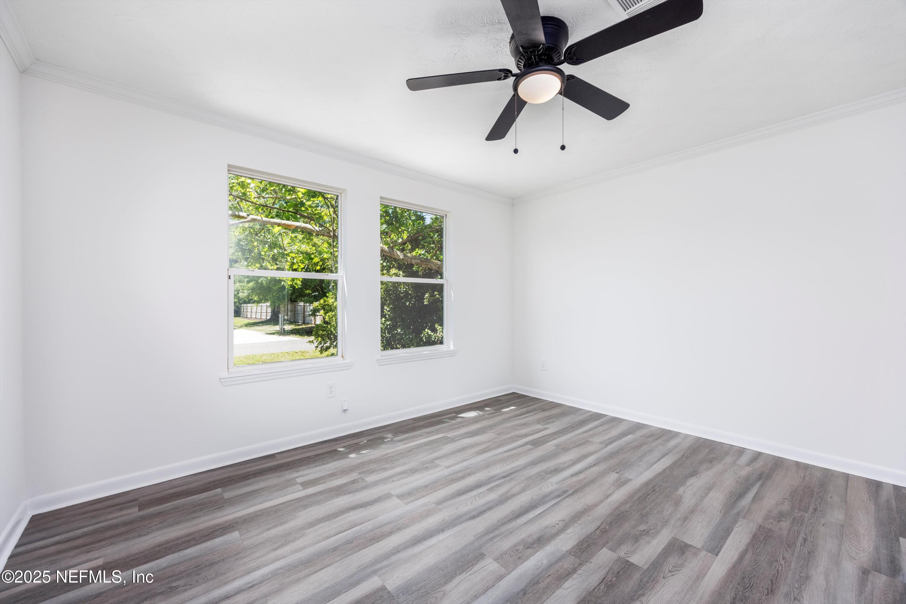900 Helen Street St. Augustine, FL 32084 - Photo 13 of 30 an empty room with a window and a ceiling fan