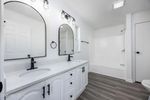 a bathroom with a double vanity sink and mirror