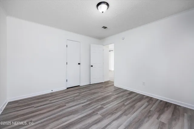 a view of room with wooden floor